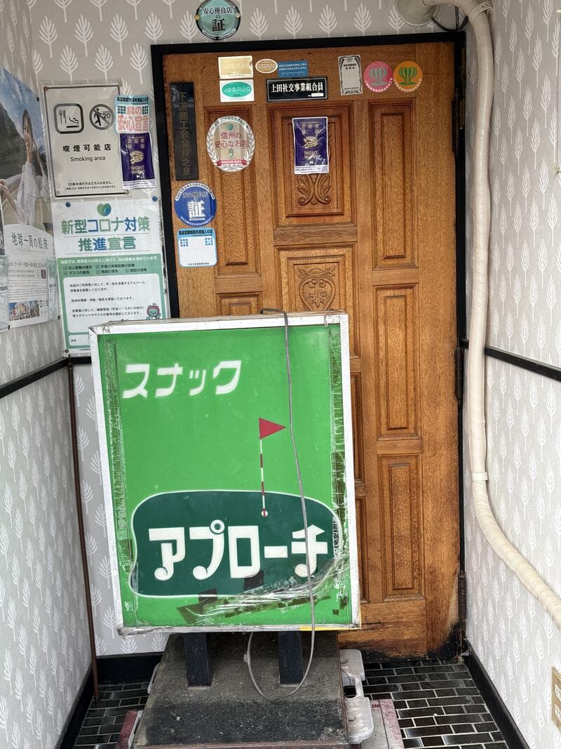 上田市中心部の階段入口に置かれた緑の「スナック アプローチ」看板