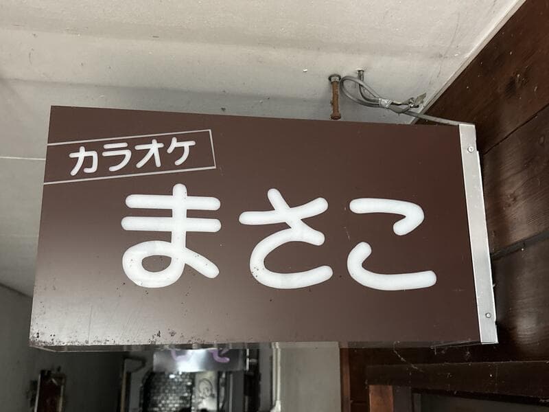茶色地の「カラオケ まさこ」看板
